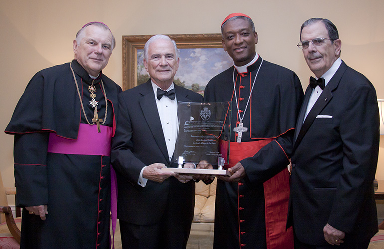 Haitian Cardinal Chibly Langlois was honored with the Tuitio Fidei Award, given to worthy Catholics for their defense of the faith, at a ceremony at the Riviera Country Club in Coral Gables. The award was presented by the Cuban Association of the Order of Malta during their annual White Cross Ball Nov. 21. To the left of the cardinal are Fernando Garcia Chacon, president of the organization, and next to him is Archbishop Thomas Wenski. To the right of the cardinal right is Juan Jose Calvo, chancellor for the organization.