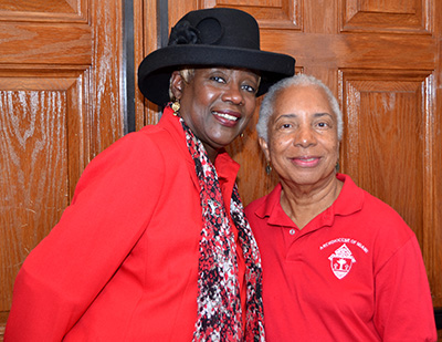 Katrenia Reeves-Jackman, director of the Office of Black Catholic Ministry, left, poses with Wilhelmina King, choir director for the Black Catholic Mass.