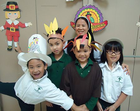 Sister Anna Kim of the Lovers of the Holy Cross of Baria poses with her students during a Thanksgiving celebration at St. Helen School in Fort Lauderdale.