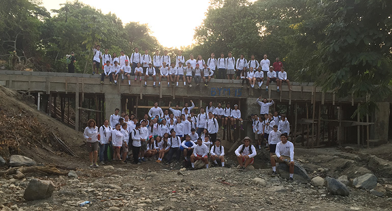 On the eve of leaving the Dominican Republic, July 4, Belen Youth Missions participants pose atop the bridge they built for the people of El Puerto.