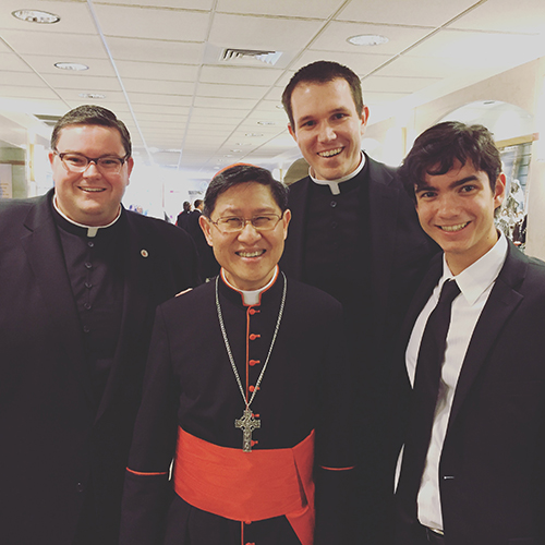 Posing with Cardinal Luis Tagle of Manila, from left: Florida seminarians Ryan Saunders of Miami; Thomas Pringle of Orlando; and Andrew Vitrano of Miami.