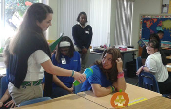 With microphone in hand, Suzette Bazan, a member of the G.R.A.C.E. Club at St. Brendan High, practices interview skills with a student from the Marian Center School. The G.R.A.C.E Club, which stands for Generating Respect and Acceptance for Children with Exceptionalities, spent the day at the Marian School Center aiding not only students, but faculty as well.