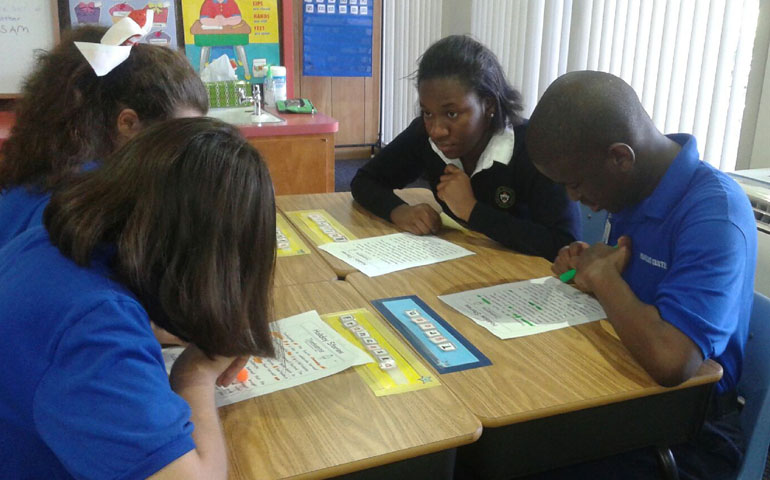 Florianne Jacques (center right), a member of the G.R.A.C.E. Club at St. Brendan High, aids with tutoring students from the Marian Center School. The G.R.A.C.E Club, which stands for Generating Respect and Acceptance for Children with Exceptionalities, spent the day at the Marian School Center aiding not only students, but faculty as well.