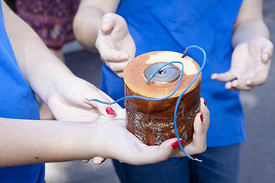 Youths hold one of two solenoids that were replaced in order to fix the bell at St. Mark Church in Southwest Ranches.