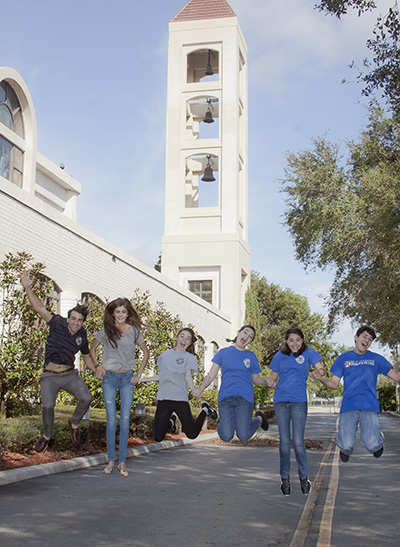 Members of the St. Mark Youth Group jump up in the air to demonstrate their excitement at achieving the repair of the bell tower. From the left is the group's youth minister,  Gustavo De La Fe, and members Melanie Bertuccelli, Karina Czubkowski, Sarah Roberge, Andrea Garza and Jose Tañón,