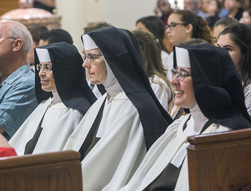 St. Theresa School Principal Sister Caridad Sandoval, far left, sits with fellow Carmelites, Sister Emma Luz and Sister Carla, during the Mass.