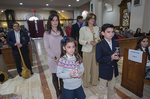 Gloria Pastoriza Smith, class of 1991, Gloria Pastoriza, class of 1966, Daniella Smith, class of 2023 and Nicolas Smith, class of 2020, bring up offertory gifts during St. Theresa School's 90th anniversary Mass.