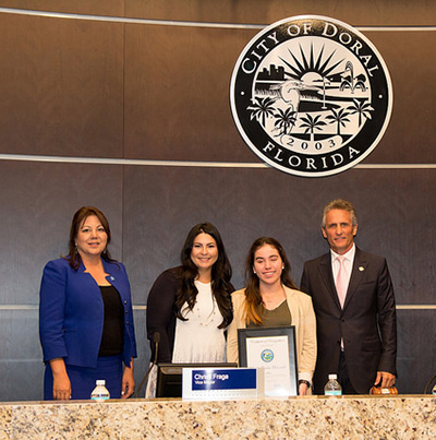 Pictured, from left, during the presentation at the Doral city council meeting: Doral Councilwoman Sandra Ruiz; Vice Mayor Christi Fraga; St. Brendan High senior Maria Mercado; and Doral Mayor Luigi Boria.