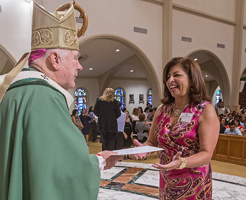 Eleonora Zelaya from the Spanish class that met at St. Brendan Church receives her School of Ministry certificate from Archbishop Thomas Wenski.