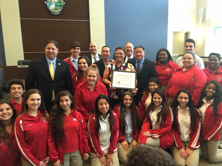 Cristina Pla-Guzman, lead teacher of Msgr. Edward Pace High School's Academy of Visual & Performing Arts Theatre Program, poses with her International Thespian Honor Society students and Miami Lakes council members after being recognized by the town council May 3.