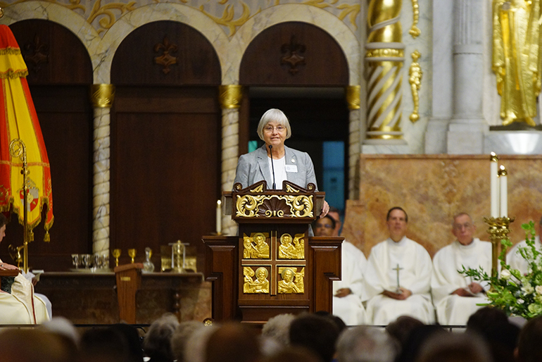 Sister Stephanie Flynn of the Sisters of St. Joseph, principal of St. James and supervising principal of Holy Family schools in North Miami, proclaims the first reading at the congregation's 150th anniversary Mass.