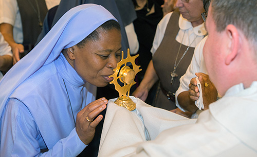 Sister Maria Philocordis, of the order of Jesus the Savior, order, kisses Mother Teresa's relic after the Mass.