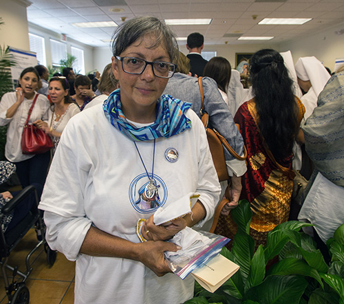 Kathleen Leger, a fulltime volunteer with the Missionaries of Charity in Miami, poses at the reception and Mother Teresa exhibit that followed the Mass.