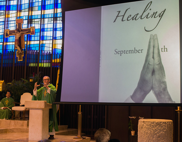 Father Damian Flanagan, parochial vicar at St. Hugh, preaches the homily at the Blue Mass.