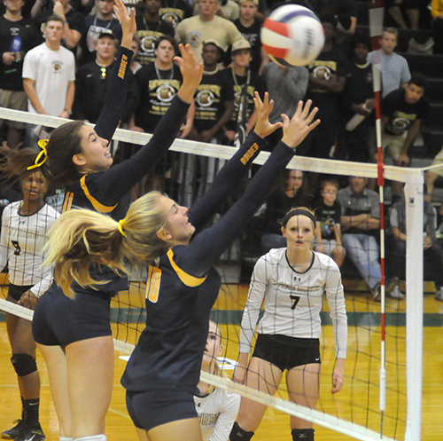 St. Thomas Aquinas' Emma Dixon (11) and Brook Bauer (5) block a Tampa Plant attack.