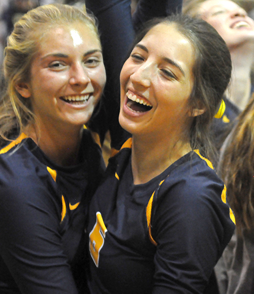 St. Thomas Aquinas players Kirsten Klos, left, and Megan Osorio celebrate their team's 25-17, 25-21, 25-21 victory over Tampa Plant in the Class 8A state volleyball championship match at West Port High School in Ocala. St. Thomas Aquinas won its third consecutive state title and fifth overall in school history.