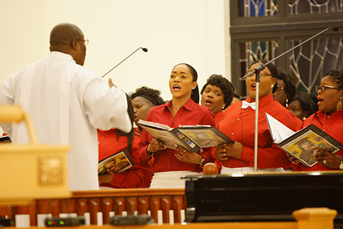 The choir sings during New Year's Eve midnight Mass at Notre Dame d'Haiti Church in Miami.