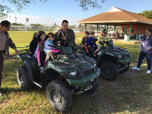 Miami-Dade officers let St. Brendan Elementary students hop on board some of the ATVs used for police work.