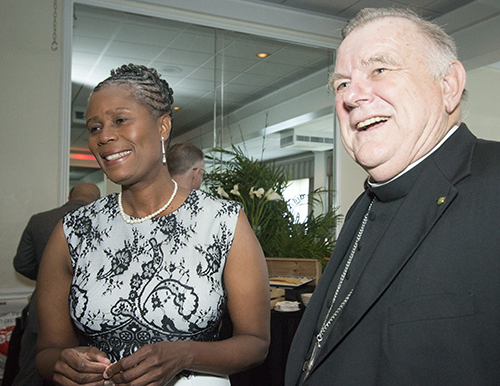 Archbishop Thomas Wenski shares a laugh with Myriam Mezadieu, chief operating officer of Catholic Legal Services, before the start of its annual New American Awards dinner, May 3 at the Miami Shores Country Club.