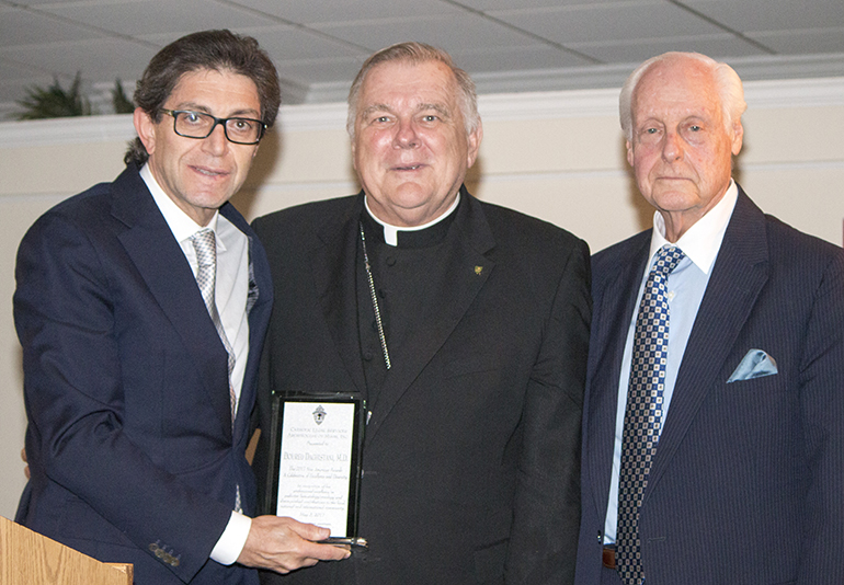 Syria-born physician Doured Daghistani, chief of staff at Baptist Hospital, receives a New American Award from Archbishop Thomas Wenski and Bruce Solow, president of the board of Catholic Legal Services, at the agency's annual dinner, May 3 at the Miami Shores Country Club.
