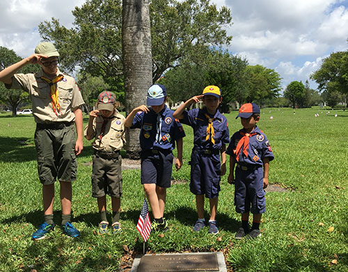 New Scouts learn the honorary salute to the graves of soldiers at Our Lady of Mercy Catholic Cemetery in Doral the Saturday before Memorial Day.