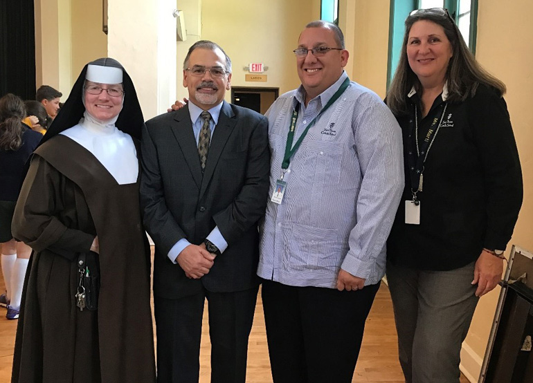 St. Theresa School faculty pose with former Supreme Court Justice Raoul Cantero, from left: Carmelite Sister Rosalie Nagy, school principal; Cantero; social studies teacher Daniel Serrano; and Vice Principal Gloria Marti.