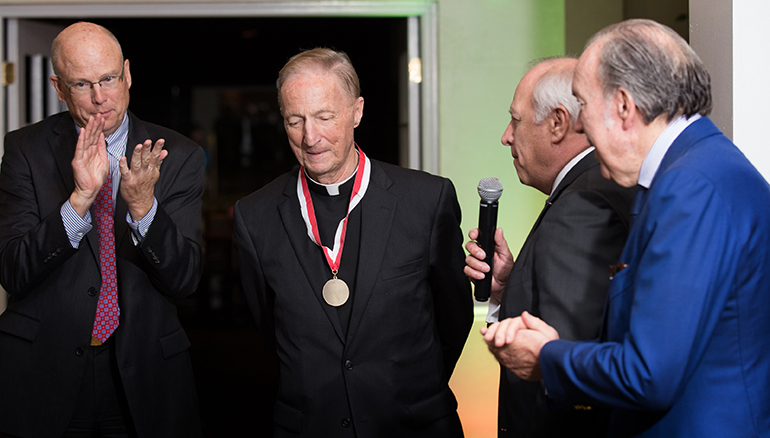 During a celebration for his 50th anniversary in the priesthood, Father Patrick O'Neill received the Order of Malta's highest honor, the President's Award, from the group's American Association. The award recognizes outstanding commitment to care of the poor and sick and to defense of the Catholic faith. Presenting the award were Malta representatives Sean Clancy, left, and Mark Wolff. Father O'Neill is a long-serving chaplain in the Order of Malta's American Association.