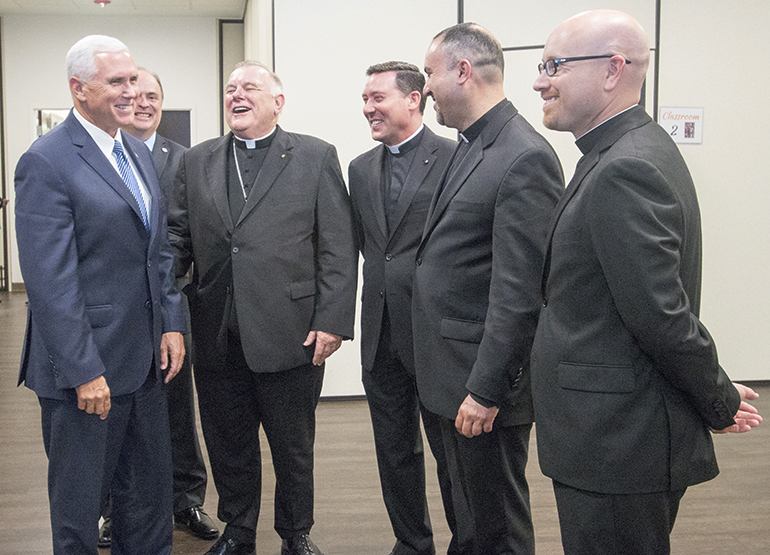 Vice President Mike Pence shares a laugh with, from left, Archbishop Thomas Wenski, Father Richard Vigoa, Father Israel Mago and Father Luis Pavon, pastor and parochial vicar, respectively, at Our Lady of Guadalupe Church in Doral.