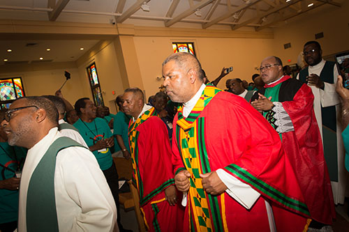 Priests wearing typical African garb enter Notre Dame d'Haiti Church in Miami for one of the Masses of the 14th National Black Catholic Men's Conference, Oct. 5-8 in Miami. Archbishop Thomas Wenski presided at the Mass.