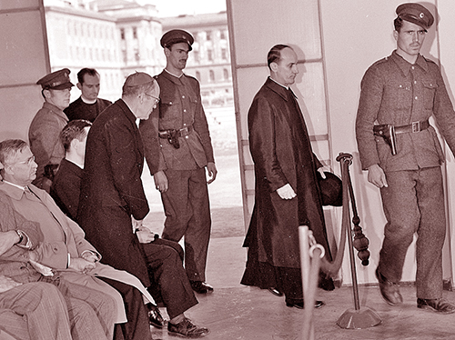 Then Bishop Joseph P. Hurley rises and bows as Archbishop Alojzijc Stepinac of Zagreb, Yugoslavia, enters a Zagreb courtroom, Oct. 11, 1946. He was being tried on charges of collaborating with the Axis.