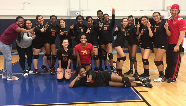 Team photo of the Pace High School girls volleyball team after defeating Mast Academy in the District semifinals Oct. 16, accompanied by coaches Markia L. Brown-Seetal and Kevin Alagret.