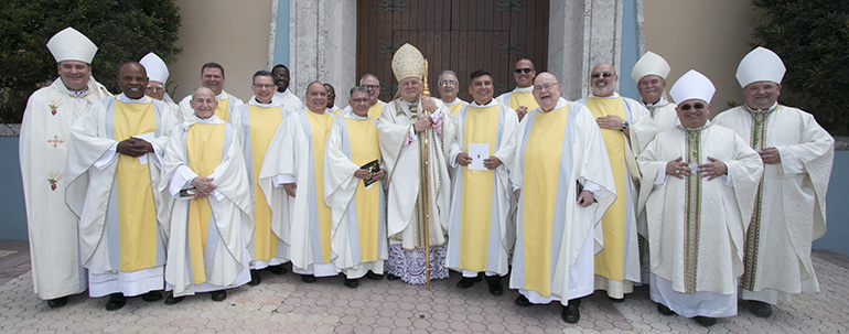 Archbishop Thomas Wenski and the concelebrating bishops pose outside St. Mary Cathedral with the priests who were honored on their 25th and 50th anniversary of ordination, at the conclusion of the chrism Mass.