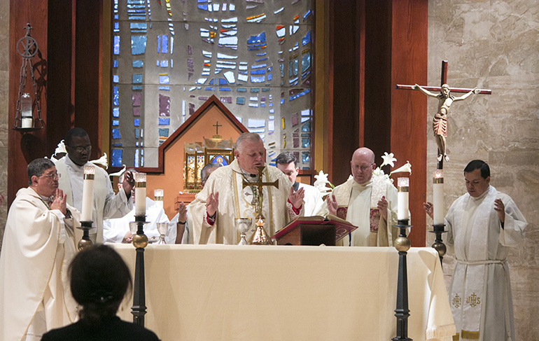 Archbishop Thomas Wenski celebrates Mass in memory of Archbishop Edward McCarthy alongside, from left, Auxiliary Bishop Enrique Delgado, Msgr. Chanel Jeanty, archdiocesan chancellor, Father Michael Davis, pastor of Little Flower in Coral Gables, and Father Elvis Gonzalez, director of Vocations. Hidden from view are Deacon Edgardo Farias, director of Detention Ministry, Msgr. Roberto Garza, director of Radio Paz 830 AM, and Father Richard Vigoa, archbishop's secretary and master of ceremonies.