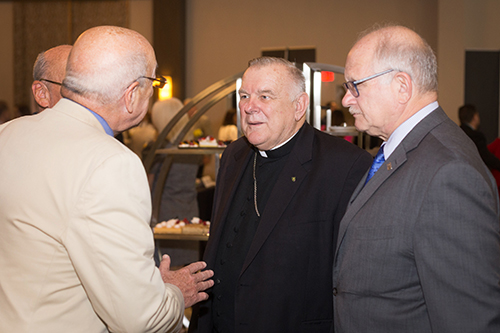 Miami Archbishop Thomas Wenski chats with area business leaders after being the guest speaker Oct. 3 at the Greater Miami Chamber of Commerce Trustee Luncheon.