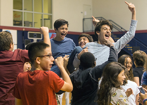 Luke Salem, 13, and Santiago Suarez, 12, from Nativity Church in Hollywood, have fun as EPIC the Band performs at Mercy Night.