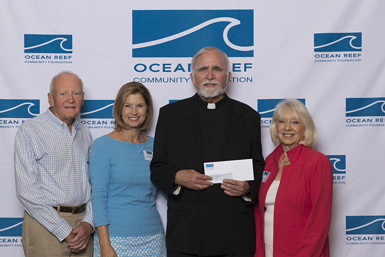 Father Stephen Hilley, pastor of St. Justin Martyr in Key Largo, poses with members of the grant committee of the Ocean Reef Community Foundation after receiving a grant of $ 23,324 from the foundation. The grant was awarded to the St. Justin Martyr Preschool, to purchase new playground equipment and install hurricane impact windows.