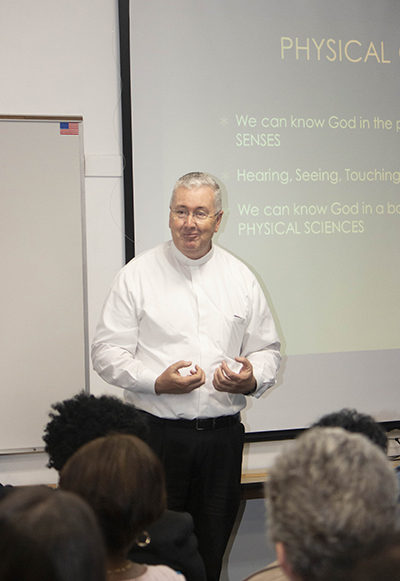 Msgr. Terence Hogan, former director of the Office of Worship and currently pastor of Mary Help of Christians in Parkland, leads the first workshop in English at the Office of Lay Ministry's annual Enrichment Day. He spoke on "Liturgy, the art of celebrating the faith of the Church," stressing that, during Mass, "the Holy Spirit is breathed in us and we go out and breathe that Spirit into the world."