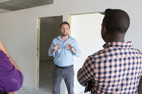 Sean O’Neill, head of office for Caritas in Grand Bahama, discusses the details of a Caritas home rehab project and resiliency center planned near Freeport, Grand Bahama, following last year's Hurricane Dorian. Miami Catholic Charities senior staff made a post-Dorian tour of key locations Feb. 19-21, 2020, led by Nassau Archbishop Patrick Pinder.