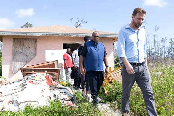 Sean O’Neill, head of office for Caritas in Grand Bahama, leads Nassau Archbishop Patrick Pinder and visitors from Miami away from one of the homes damaged by Hurricane Dorian in Freeport that is being refurbished with help from Caritas. Miami Catholic Charities senior staff made a post-Hurricane Dorian tour of key locations Feb. 19-21, 2020, with Archbishop Pinder.