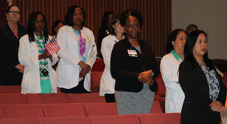 Doctors, nurses, staff and guests of Holy Cross Hospital gather for ceremonies March 6, 2020 to announce a new program now in place aimed at taking better care of veterans and active military of the community.