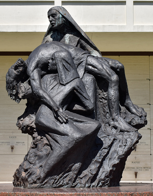 Two women cradle the body of Jesus in this unusual Pieta at Our Lady of Mercy Cemetery, Doral.