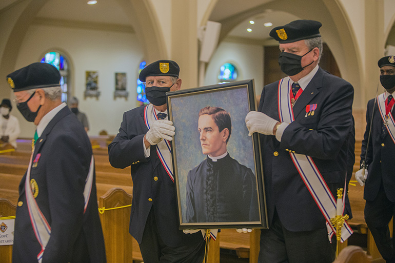 Knights of Columbus Robert Read and John O'Toole, carry a picture of Father Michael McGivney into St. Mary Cathedral at the start of a Mass to mark their founder's beatification, Oct. 31, 2020. The Mass was celebrated by Archbishop Thomas Wenski.