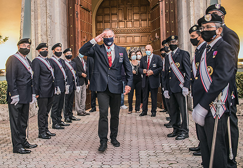 Michael Gizewski, Florida State Council State Warden, salutes fellow Knights of Columbus after the Mass to mark the beatification of their founder, Father Michael McGivney. The Mass was celebrated by Archbishop Thomas Wenski Oct. 31, 2020, at St. Mary Cathedral in Miami.