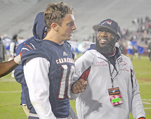 Chaminade-Madonna coach Dameon Jones, right, and senior safety-receiver Michael Edwards leave the field after the Lions' 25-22 loss to Jacksonville Trinity Christian in the Class 3A FHSAA Football State Championship Game.