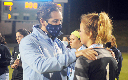 Lourdes coach Ramiro Vengoechea consoles goalkeeper Mia Alexander after Our Lady of Lourdes Academy's 0-0, 3-1 penalty-kicks loss to Venice, March 5, 2021 in the FHSAA Class 6A Girls Soccer Championship Game at Spec Martin Stadium in DeLand.