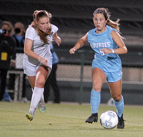 Lourdes sophomore midfielder Coco Aguilar tries to keep the ball from Venice's Trinity Johnson during the second half of Our Lady of Lourdes Academy's 0-0, 3-1 penalty-kicks loss to Venice, March 5, 2021 in the FHSAA Class 6A Girls Soccer Championship Game at Spec Martin Stadium in DeLand.