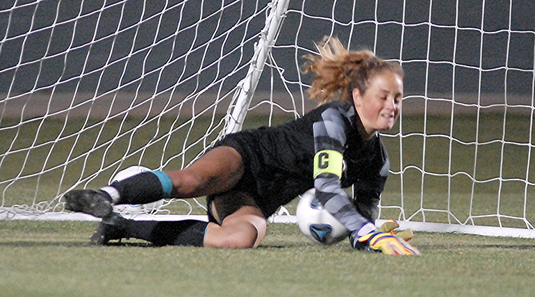 Lourdes goalkeeper Mia Alexander saves a penalty kick during the shootout phase of Our Lady of Lourdes Academy's 0-0, 3-1 penalty-kicks loss to Venice, March 5, 2021 in the FHSAA Class 6A Girls Soccer Championship Game at Spec Martin Stadium in DeLand.