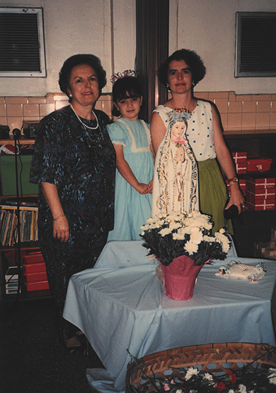 Florida Catholic reporter Cristina Cabrera Jarro (center) is accompanied by her mother, Maria Cabrera (right), and her grandmother, Maria Jarro, after a celebration in honor of the Virgin Mary in 1993 at Centro Hispano Catolico child care center.