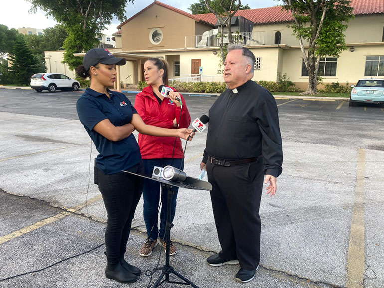 Father Juan Sosa, pastor of St. Joseph Church, Miami Beach, the parish nearest to the collapsed condo building in Surfside, speaks to the media before the 8 a.m. Mass June 25, 2021, which was offered for the victims. Father Sosa said 10 of his parish families who lived in the building are unaccounted for, while two more are accounted for.