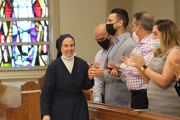 Sister Eva Perez Puelles and other Daughters of Charity of St. Vincent de Paul are applauded by family, friends and supporters for their service to Miami during a Mass at St. Mary Cathedral on Aug. 14, 2021 celebrating 50 years since the religious community arrived in Miami.